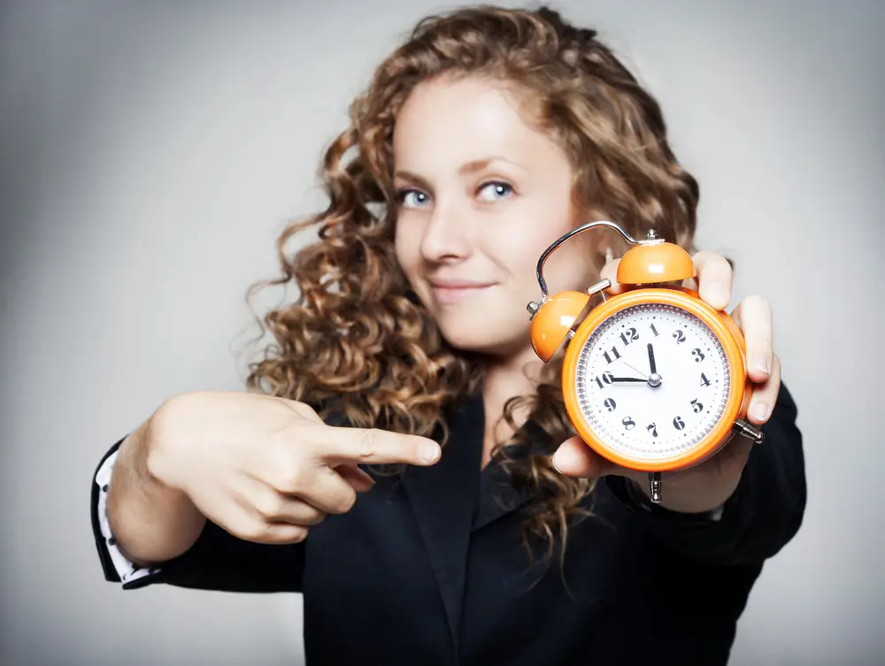woman pointing at clock